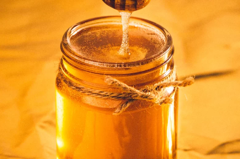 Honey with honey stick dripping
